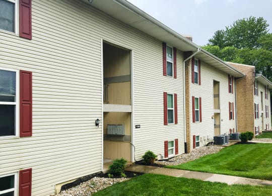 a side view of a white house with red doors at Timber Ridge Apartments, Ohio