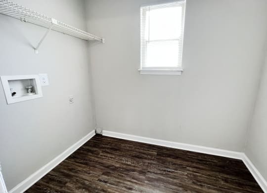a small room with a wooden floor and a small window at 450 on Keeneland, Richmond