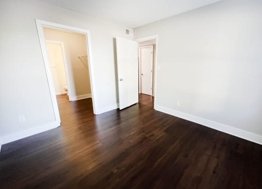 a bedroom with hardwood floors and white walls at 450 on Keeneland, Richmond, KY