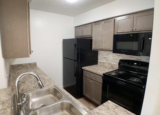 Updated Kitchen With Black Appliances at Steeplechase Apartments, Loveland