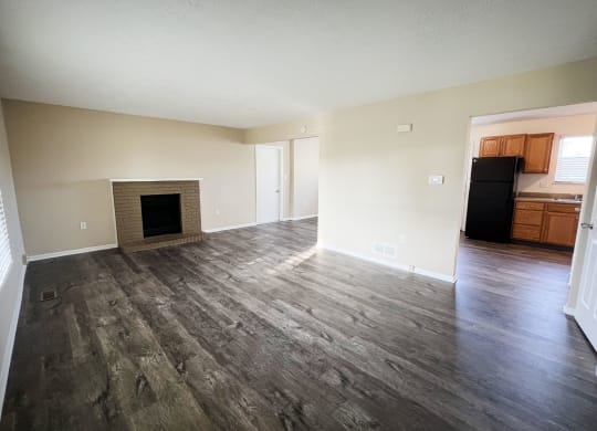 an empty living room with wooden floors and a fireplace  at The Villas at Kingswood, Ohio, 45069