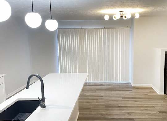A modern kitchen with a white countertop and a black dishwasher.