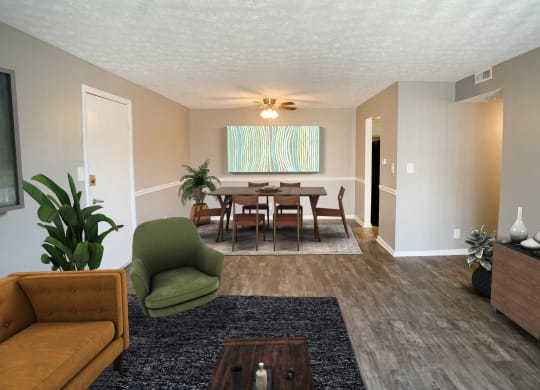 a living room and dining room with a table and chairs  at Knobs Pointe Apartments, New Albany, Indiana