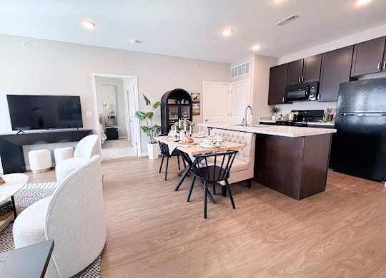 A modern kitchen with a dining table and chairs.
