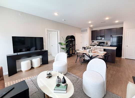 A modern living room with a white sofa and a black coffee table.