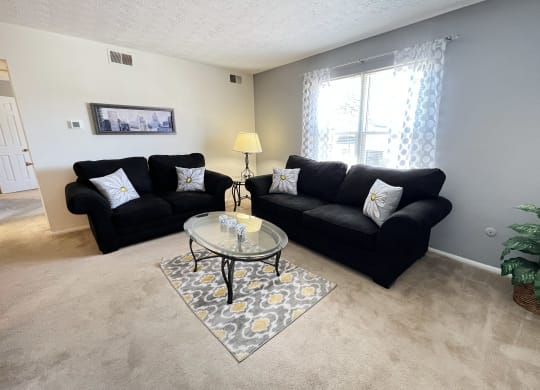 a living room with couches and a coffee tableat Revere Village Apartments, Centerville, Ohio