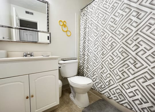 a white bathroom with a shower and a toiletat Revere Village Apartments, Centerville, OH