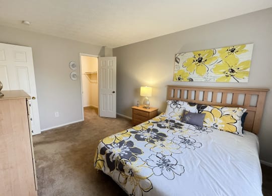 a bedroom with a bed and a door to a bathroomat Revere Village Apartments, Ohio, 45458