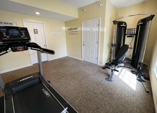 a home gym with a treadmill and exercise equipmentat Revere Village Apartments, Centerville, 45458
