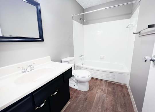 A white sink and toilet in a small bathroom.