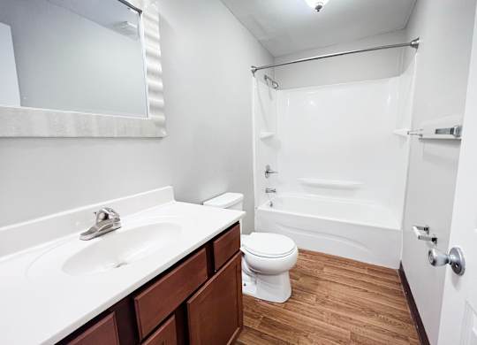A white sink and toilet in a small bathroom.