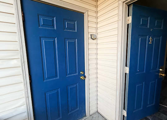 A blue door with a keyhole and a doorknob.