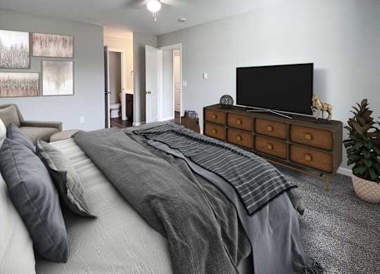 A bedroom with a large bed and a television on a dresser.