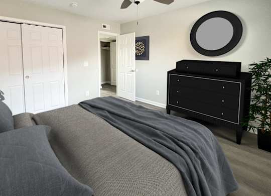 a bedroom with a bed and a dresser