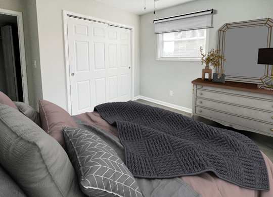 a bedroom with a bed with pillows and a dresser