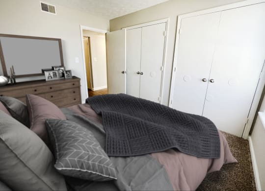 a bedroom with a bed and a dresser with a mirror on it at 450 on Keeneland, Kentucky