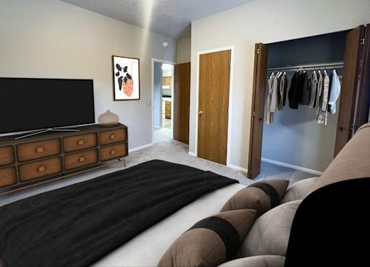 A bedroom with a large bed and a TV.
