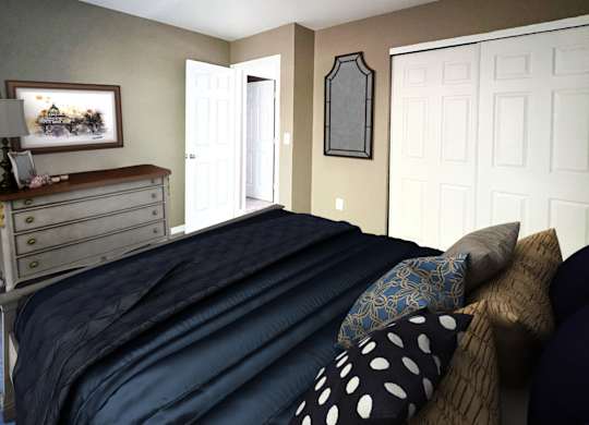 A bedroom with a bed, dresser, and mirror.