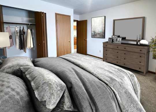 A bedroom with a large bed and a wooden dresser.