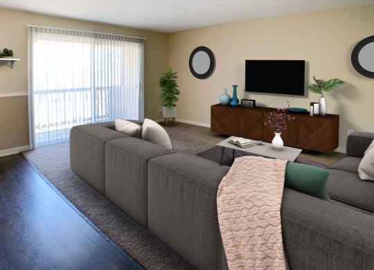 a living room with a gray couch and a television  at Timber Ridge Apartments, Cincinnati, OH, 45241