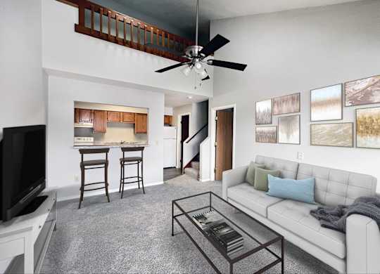 A living room with a white couch, a television, and a bar area.