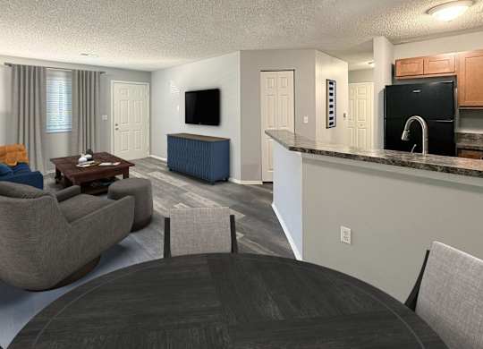 A modern living room with a dark wood table and grey couch.
