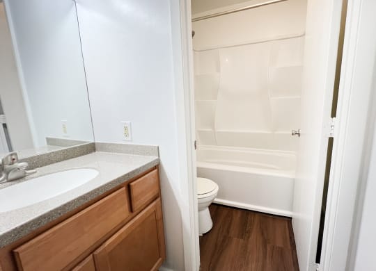 a bathroom with a sink toilet and shower and a mirror at Walnut Creek Townhomes, Cincinnati