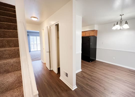 a renovated living room and kitchen with hard wood flooring and a staircase at Walnut Creek Townhomes, Cincinnati
