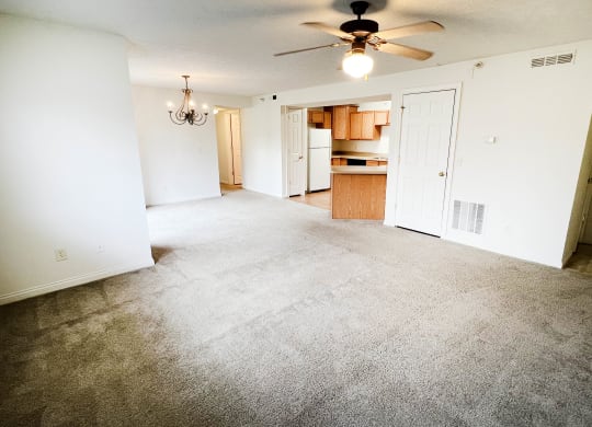 an empty living room with carpet and a ceiling fan  at Walton Ridge Apartments, Walton, Kentucky