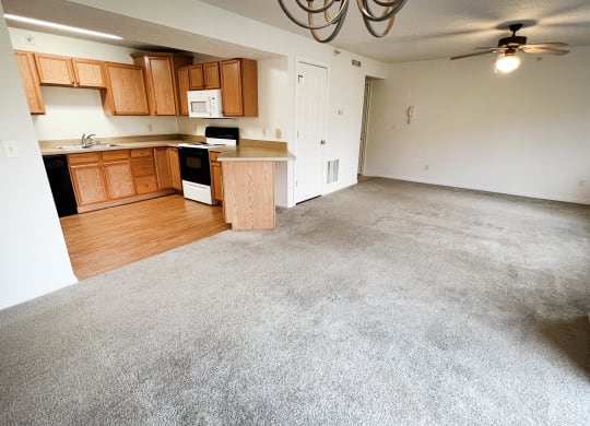 an empty living room and kitchen in a house  at Walton Ridge Apartments, Walton, KY, 41094
