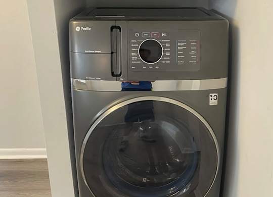 A front-loading washing machine with a transparent door.