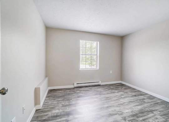 A room with a window and a door.