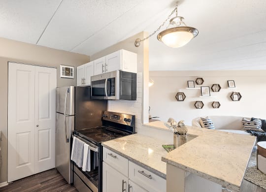 a fully equipped kitchen with granite countertops and stainless steel appliances