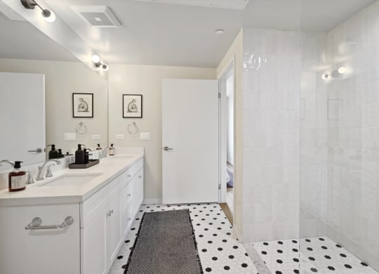 a bathroom with a shower and a sink and a rug The Baxter in Los Angeles, CA 90028