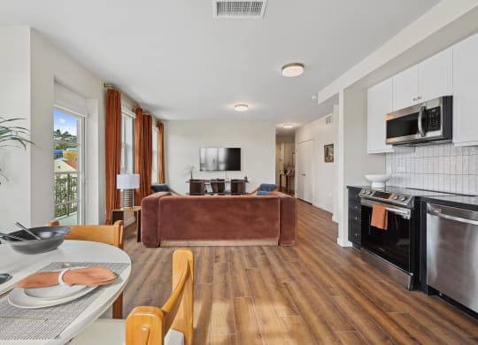 a living room with a leather couch and a table with chairs The Baxter in Los Angeles, CA 90028