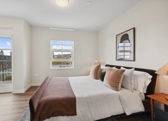 a bedroom with a large bed and two windows The Baxter in Los Angeles, CA 90028