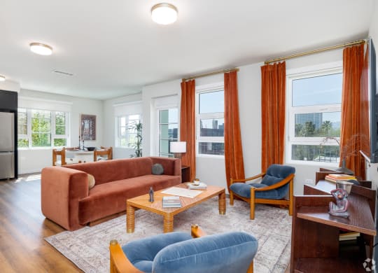 a living room with orange curtains and a brown couch The Baxter in Los Angeles, CA 90028