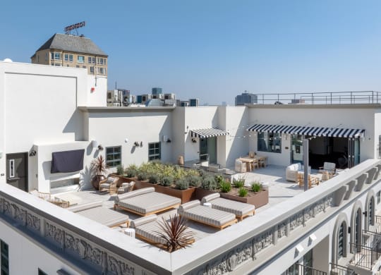 a roof terrace with furniture and a city in the background The Baxter in Los Angeles, CA 90028