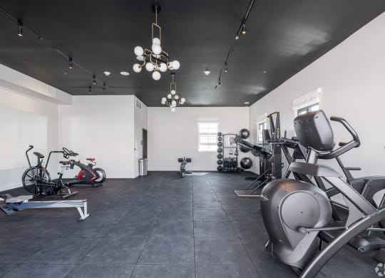 a gym with various machines and bikes in it The Baxter in Los Angeles, CA 90028