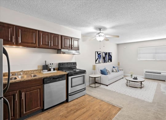 a kitchen and living room with a ceiling fan