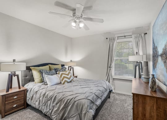 a bedroom with a bed and a ceiling fan at Pebblebrook, Overland Park, Kansas