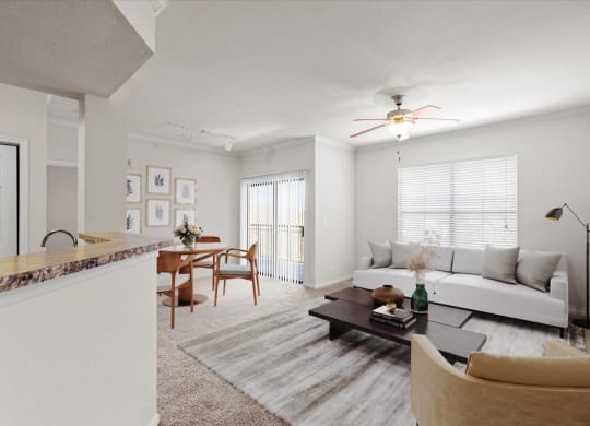 A living room with a ceiling fan, a large window, and a patio entrance in the dining room.