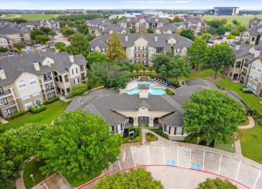 an aerial view of a large house with a swimming pool in the middle of it