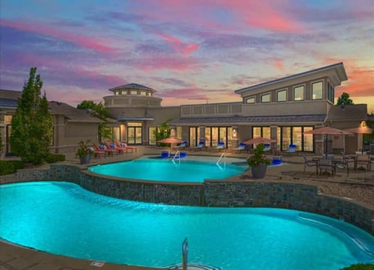 a large swimming pool with a building in the background