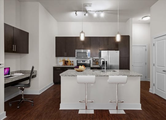 a kitchen with an island and a table with chairs