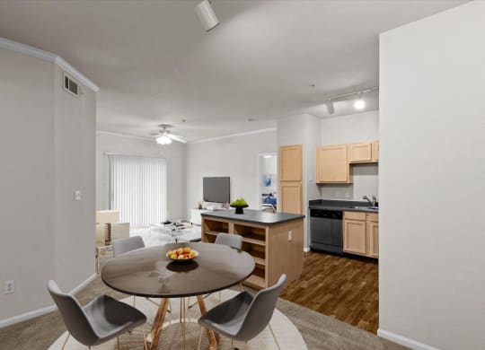 a dining room and kitchen with a table and chairs at Stonepost Lakeside, Olathe