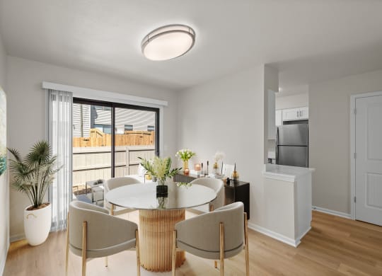 a living room and dining room with a table and chairs