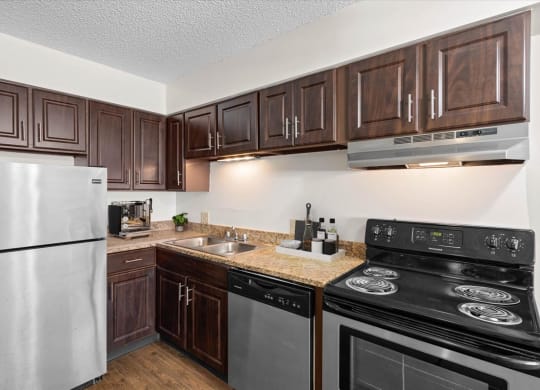 a kitchen with stainless steel appliances and wooden cabinets