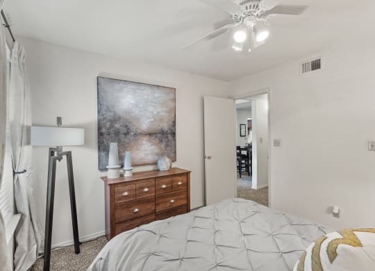 a bedroom with a bed and a dresser at Pebblebrook, Overland Park, 66212
