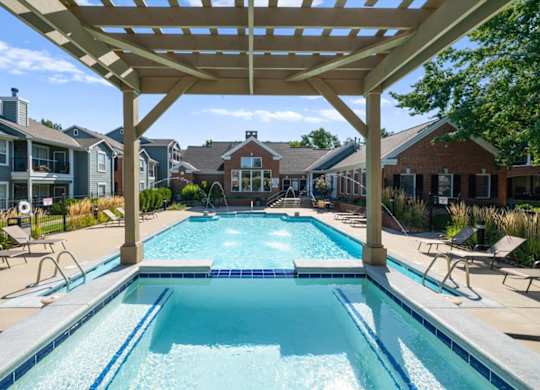 A large swimming pool under a wooden pergola. at Somerset Oaks Apartment Homes, Olathe 66062